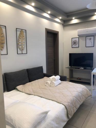 a bedroom with a bed with towels on it at Xenia_Apartments A6 in Kozani