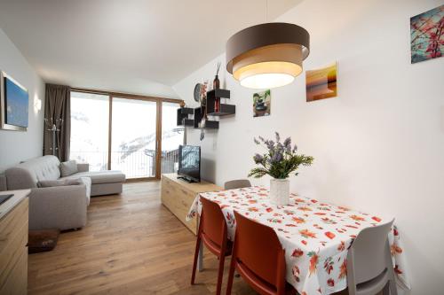 a living room with a table with a vase on it at Casa Noemi in Livigno