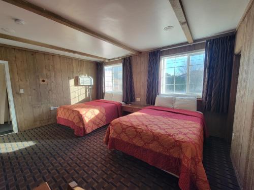 a hotel room with two beds and a window at Townhouse Motel in Bishop