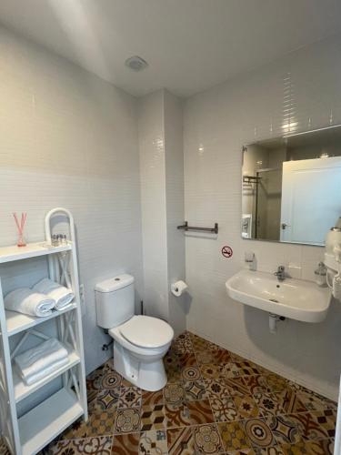 a bathroom with a toilet and a sink at Galeon Boutique Hotel in Calpe
