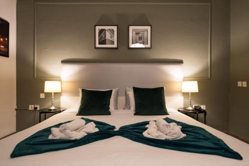 a bed with a white bedspread and pillows at Sliema Marina Hotel in Sliema