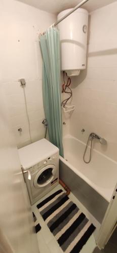 a small bathroom with a toilet and a shower at 3pko City center apartment in Banja Luka