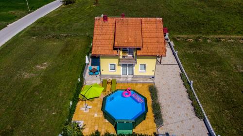 an aerial view of a house with a swimming pool at House of inspiration above LAKE Sabljaci with pool in Ogulin
