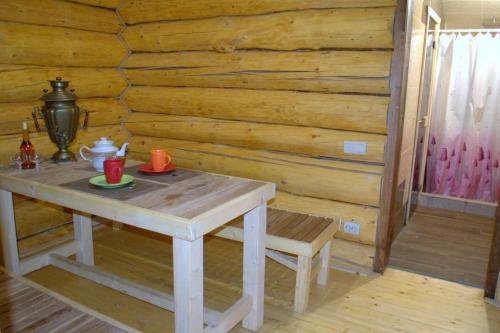 a table in a room with a wooden wall at U Druziv in Polyana