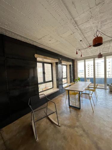 an empty room with a table and chairs in it at Bethlehem City Hostel in Bethlehem