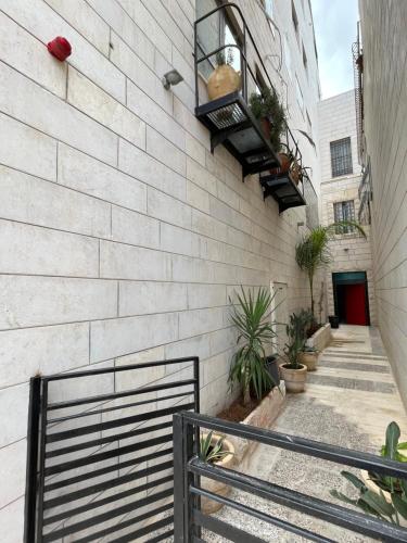 a brick wall with a staircase and a building at Bethlehem City Hostel in Bethlehem