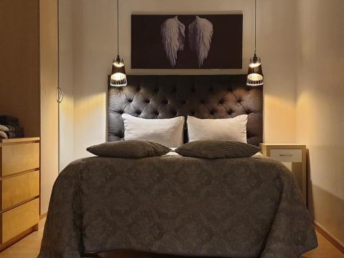a bedroom with a large bed with two pillows at University City Heart, Tartu Home in Tartu