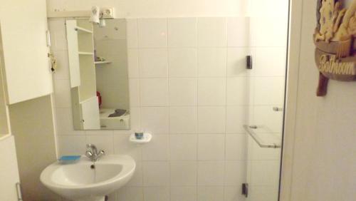 a bathroom with a sink and a shower with a mirror at Comfortable apartment in Flic en Flac 74 sqm sea view in Flic-en-Flac