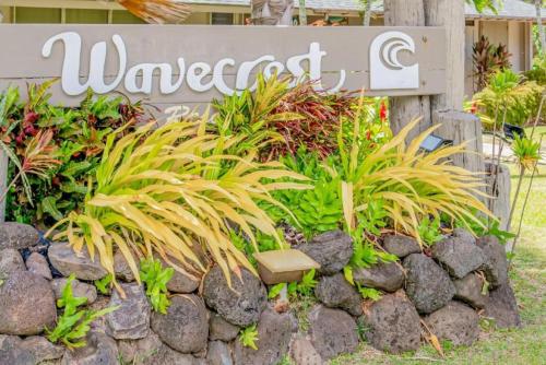 a sign for a garden with plants and a stone wall at Molokai Island Retreat with Beautiful Ocean Views and Pool - Newly Remodeled! in Ualapue