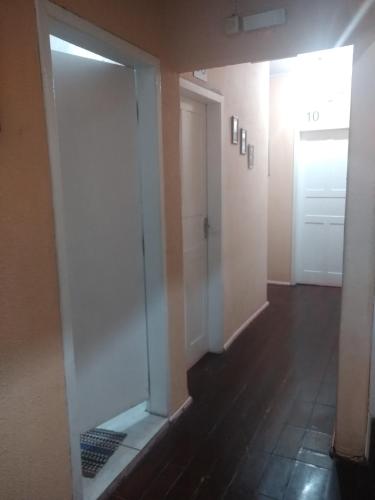 a hallway with a glass door and a hallway with a door at Pousada Jardim Alameda in Blumenau