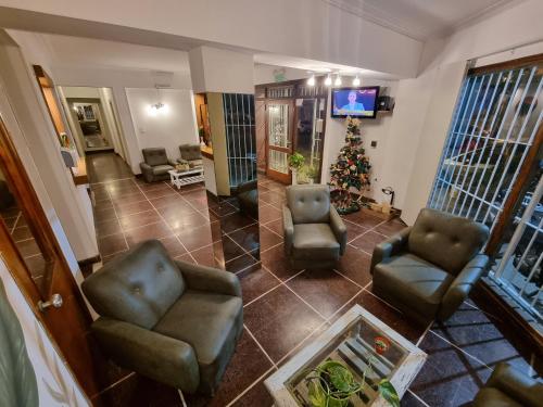 a living room with two chairs and a christmas tree at Hotel Mar in Mar del Plata