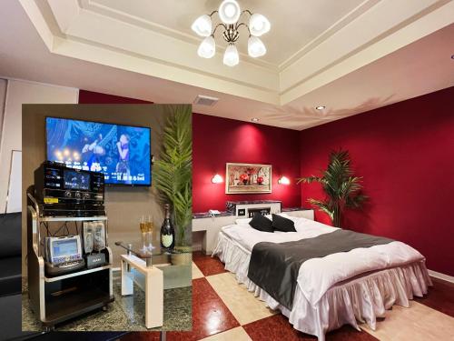 a bedroom with a large bed and a flat screen tv at Hotel LEXY旧Tsubakikan Adult Only in Nara