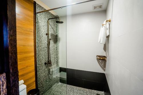 a bathroom with a shower with a glass door at Good Time Relax Resort in Kampot