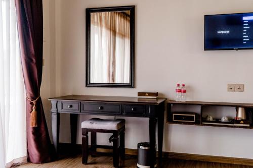a dressing table with a chair and a mirror at Good Time Relax Resort in Kampot
