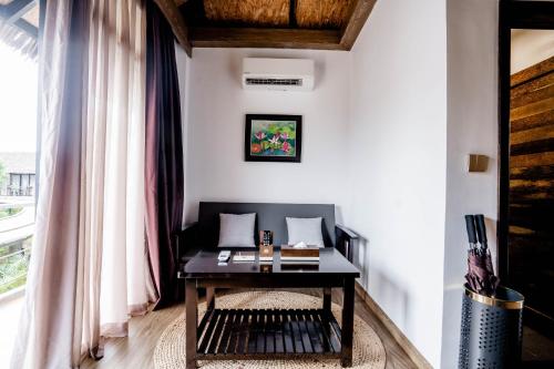 a living room with a table and a window at Good Time Relax Resort in Kampot