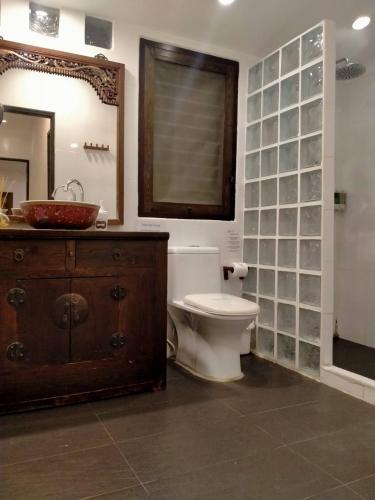 a bathroom with a toilet and a sink and a mirror at BTC Hua Hin Home managed by BTC Boutique Resort in Hua Hin
