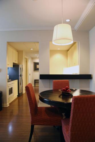 a kitchen and dining room with a table and chairs at At 21 Saladaeng in Bangkok