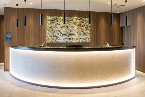 a lobby with a reception desk in a building at The Hedistar Hotel Kyoto Nijo Comic & Books in Kyoto