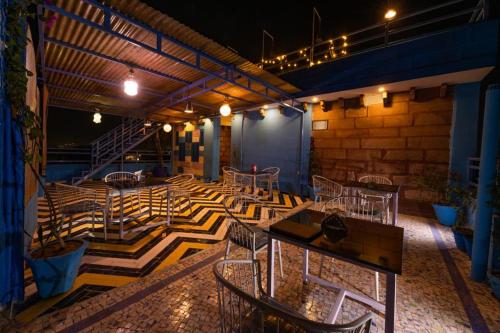 a patio with tables and chairs and a staircase at Swiss House in Jodhpur