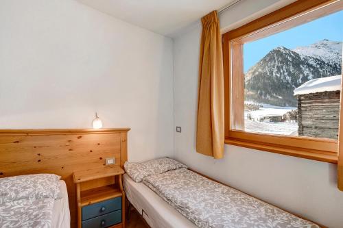 A bed or beds in a room at Appartamento Vago