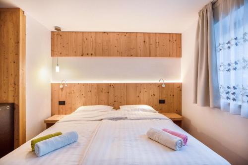 a bedroom with a bed with two pillows on it at Chalet Osmar Suite 1 in Campitello di Fassa