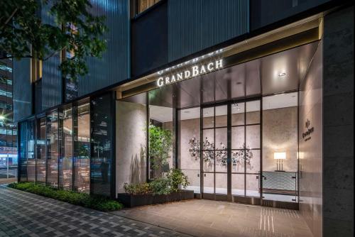 a store front of a building at night at Hotel GrandBach Tokyo Ginza in Tokyo