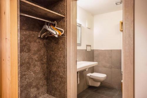 a bathroom with a toilet and a sink at Chalet Osmar Suite 2 in Campitello di Fassa