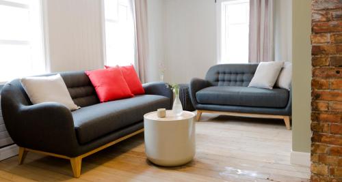 a living room with two couches and a table at Old Charm Reykjavik Apartments in Reykjavík