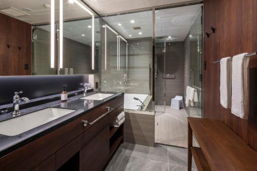 a bathroom with a sink and a shower at Hotel GrandBach Tokyo Ginza in Tokyo