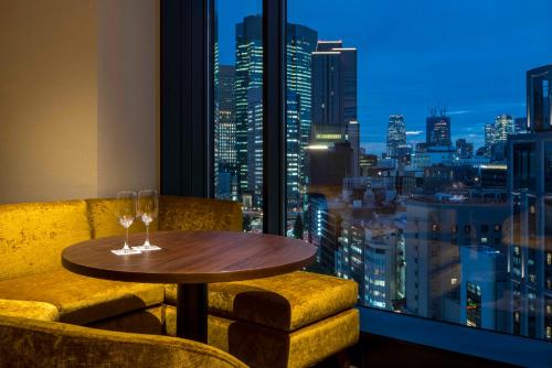 a table in a room with a view of a city at Hotel GrandBach Tokyo Ginza in Tokyo