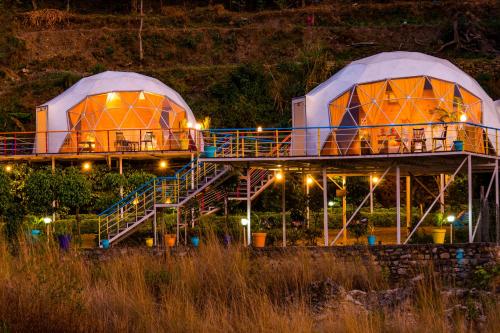 two domed buildings with stairs and lights at night at goSTOPS Dehradun, Maldevta in Dehradun