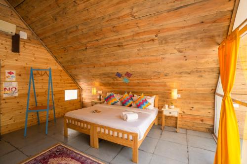 a bedroom with a bed in a wooden room at goSTOPS Dehradun, Maldevta in Dehradun