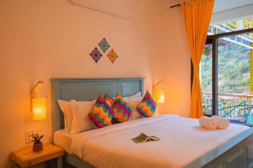 a bedroom with a bed with orange walls and a window at goSTOPS Dehradun, Maldevta in Dehradun