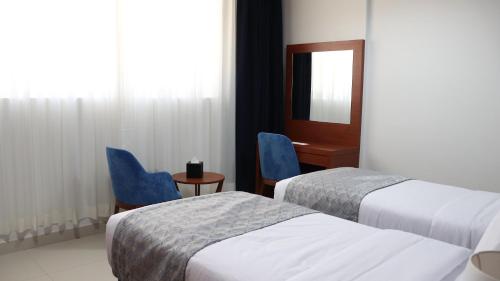 Ένα ή περισσότερα κρεβάτια σε δωμάτιο στο Al Riyadh Hotel Apartments
