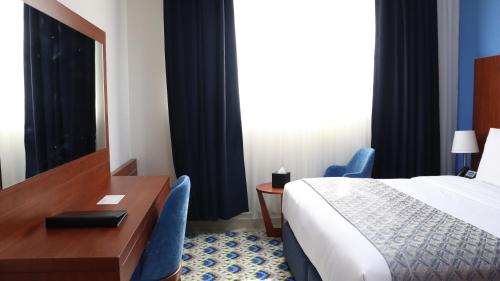 Ένα ή περισσότερα κρεβάτια σε δωμάτιο στο Al Riyadh Hotel Apartments