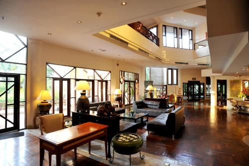 a large living room with a lot of windows at Felix River Kwai Resort - SHA Plus,Certified in Kanchanaburi