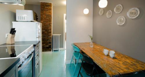 a kitchen with a wooden table and a refrigerator at Old Charm Reykjavik Apartments in Reykjavík