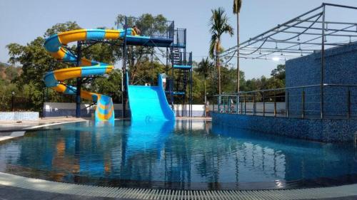 a water park with a slide in the water at Cold Spot Village Resort in Mahabaleshwar