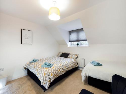 a bedroom with two beds and a window at Cheerful 5-BDR/3-BATH House w/ Free Parking in Reading