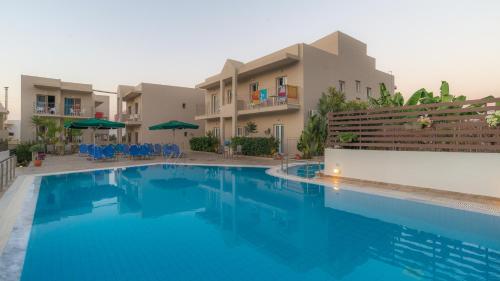 een zwembad voor een gebouw bij Creta Verano Hotel in Malia