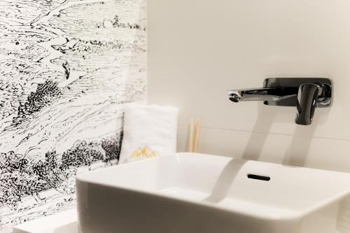 a bathroom with a sink and a faucet at Royal Apartments & Spa Zakopane-Cyrhla in Zakopane