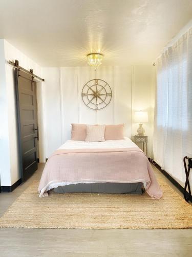 a bedroom with a large bed with a pink blanket at The Shack Inn in Homer