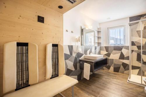 uma casa de banho com um lavatório e um espelho em Apartment Sis Residence Bun Ste em San Vigilio Di Marebbe