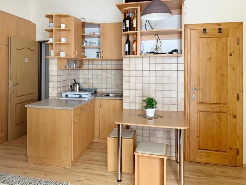 a small kitchen with wooden cabinets and a table at Hotel Hvezda in Pec pod Sněžkou