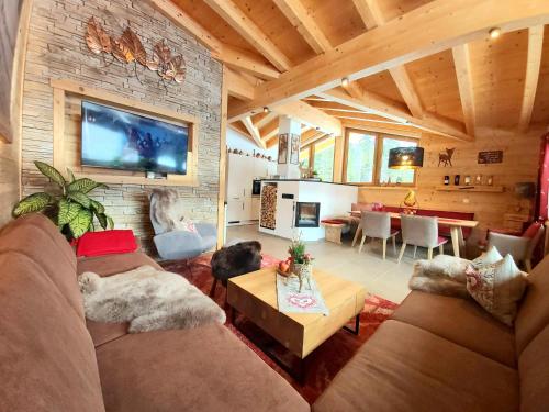 a living room with a couch and a table at Puitbach Chalet in Leutasch