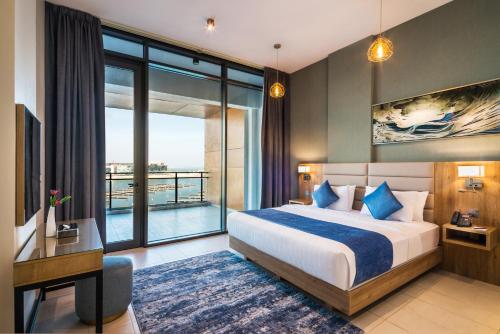 a hotel room with a bed and a large window at Boudl Al Jubail in Al Jubail
