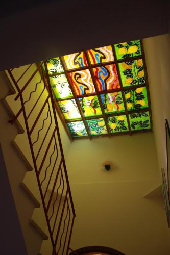 a ceiling with a stained glass window in a room at Hotel Edelweiss in Erice