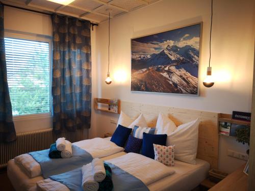 a bedroom with a bed with two pillows at APARTMENT WALD - im Skigebiet Gerlitzen & Ossiacher See in Bodensdorf