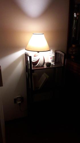a lamp sitting on a table in a dark room at Monferrato Inn in Rivarone