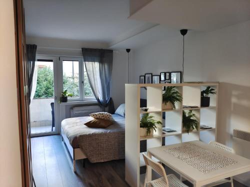 a small bedroom with a bed and a table and a desk at Girasole Trento in Trento